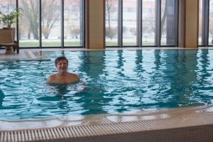 Happy,Man,In,Pool,With,Panoramic,Windows